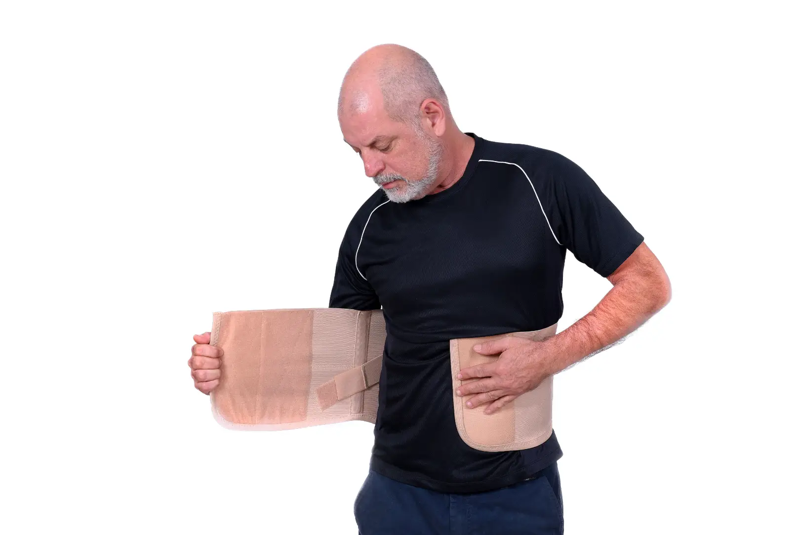 Man fastening a beige compression garment around his abdomen over a black shirt.